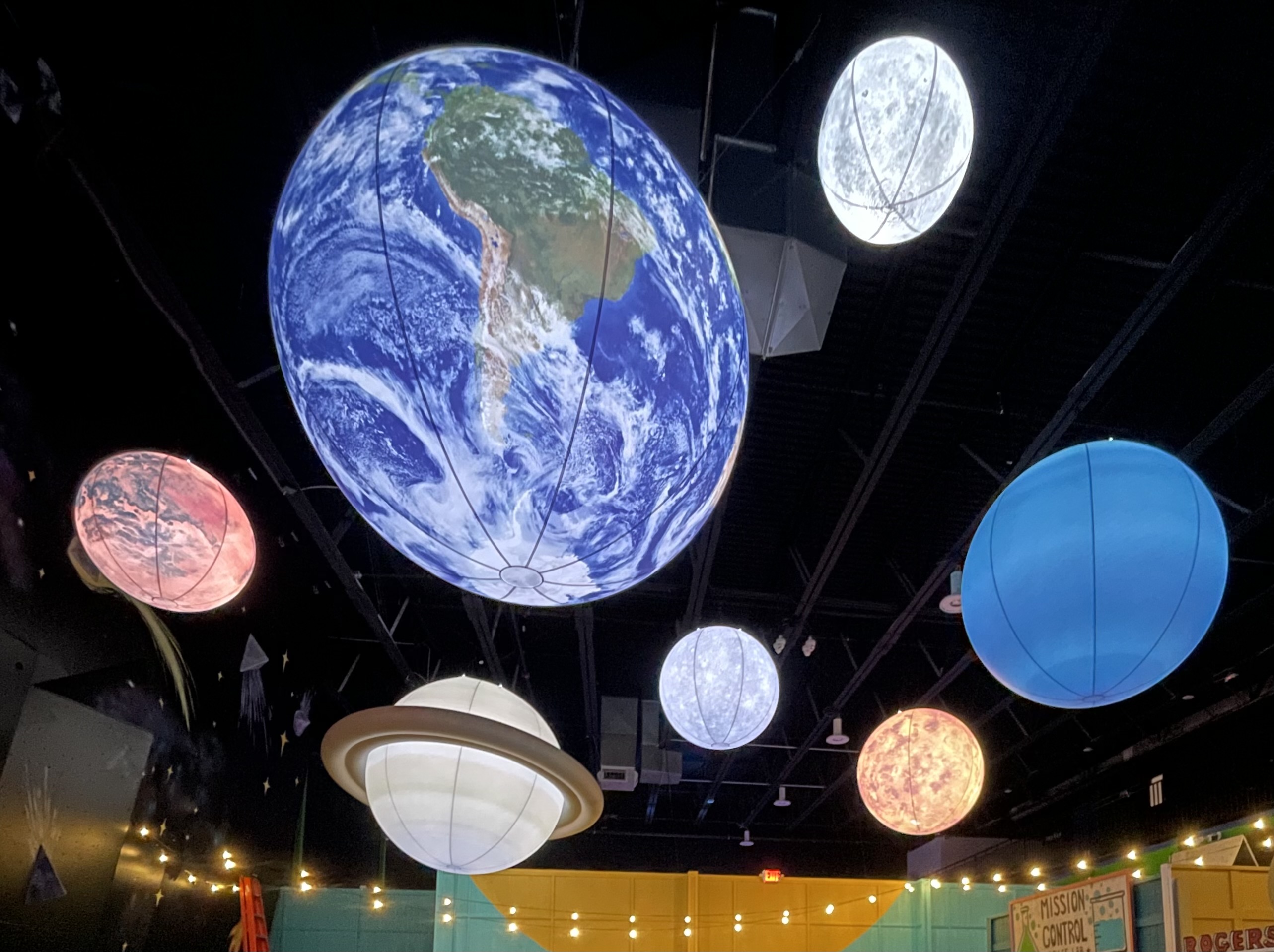 Illuminated planets inside Starbase Kids Space